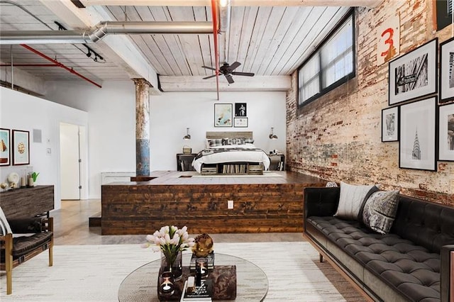 living room with brick wall, track lighting, and ceiling fan