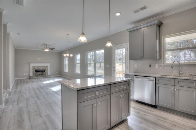 kitchen featuring gray cabinetry, dishwasher, a sink, ornamental molding, and a ceiling fan