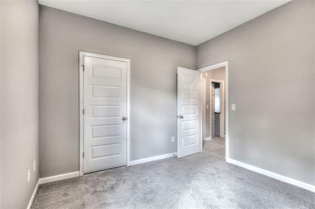 unfurnished bedroom with carpet and baseboards