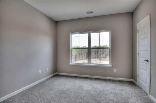 unfurnished room featuring carpet and baseboards