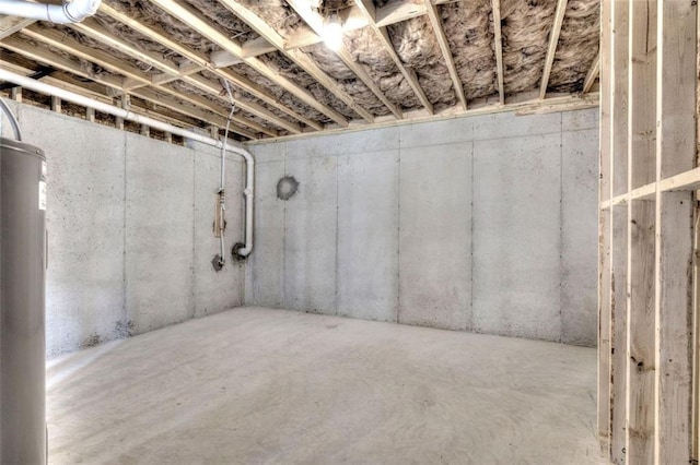 unfinished below grade area featuring water heater