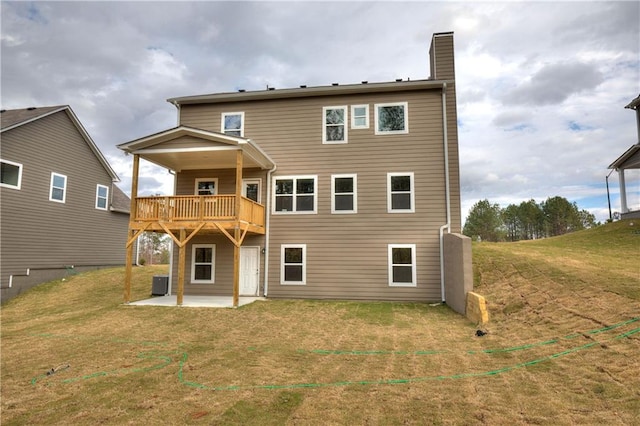 rear view of house featuring a patio area, cooling unit, and a yard