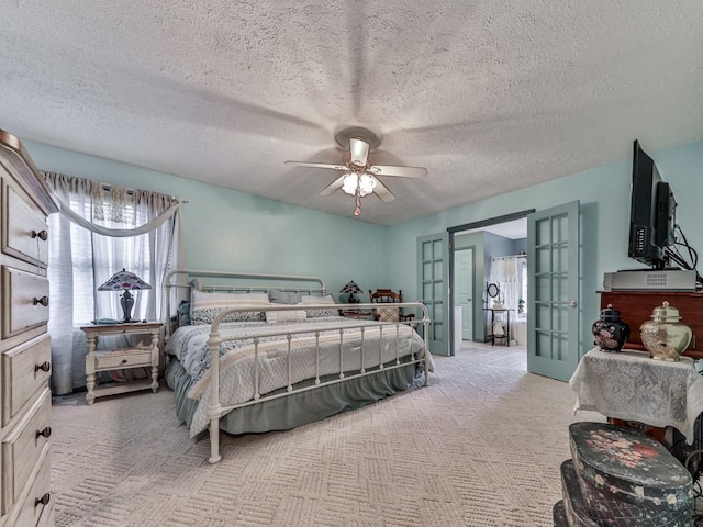 carpeted bedroom featuring a textured ceiling, french doors, and ceiling fan