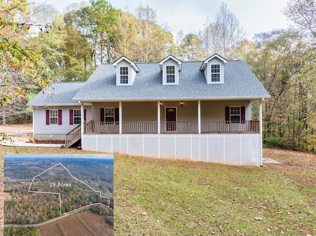 new england style home with covered porch and a front yard