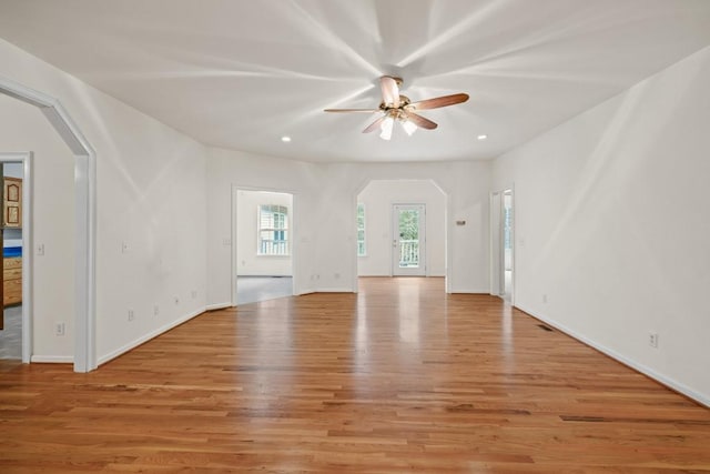 unfurnished living room featuring ceiling fan and light hardwood / wood-style flooring