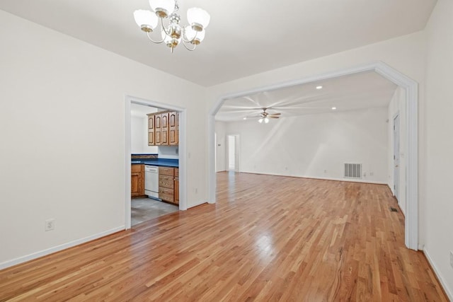 unfurnished living room with ceiling fan with notable chandelier and light hardwood / wood-style floors