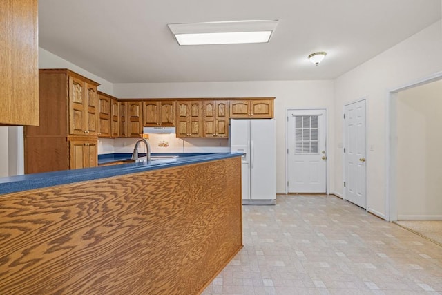 kitchen with sink and white refrigerator