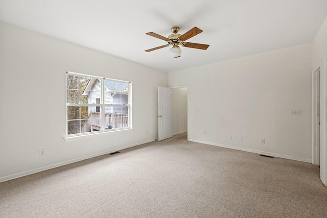 carpeted spare room with ceiling fan