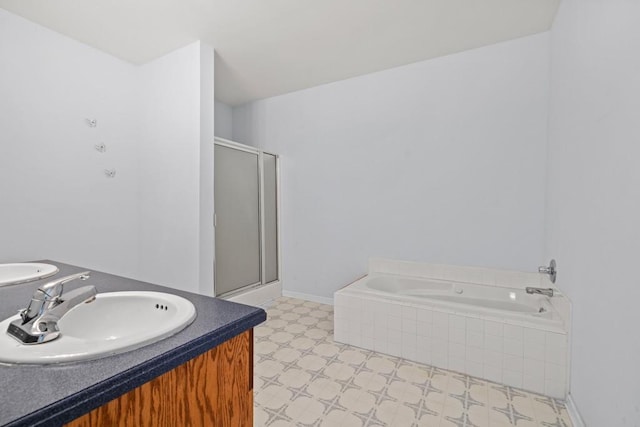 bathroom featuring plus walk in shower and vanity