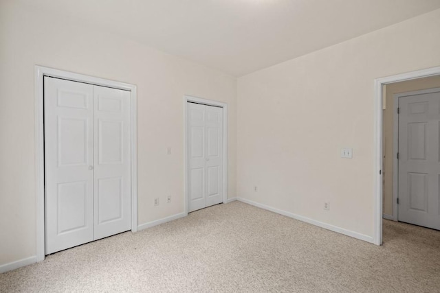 unfurnished bedroom featuring light carpet