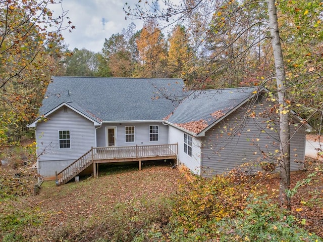 rear view of property featuring a wooden deck