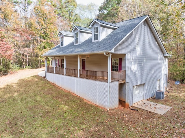 view of side of home featuring central AC unit, a garage, a lawn, and covered porch