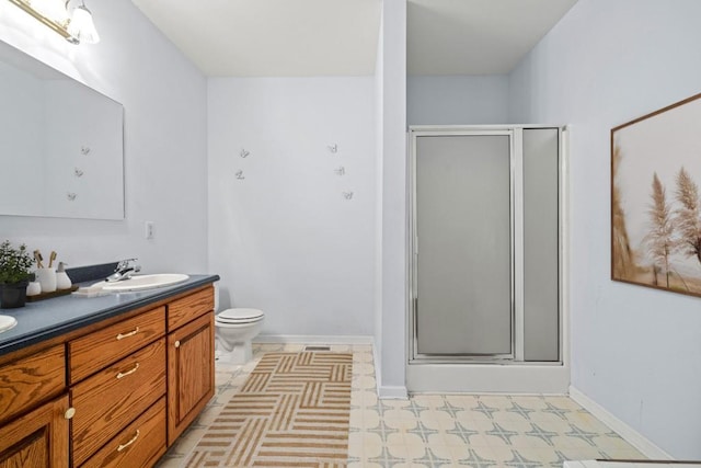 bathroom with vanity, toilet, and an enclosed shower