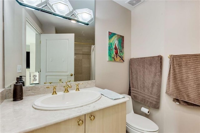 bathroom featuring vanity, a shower with shower curtain, and toilet