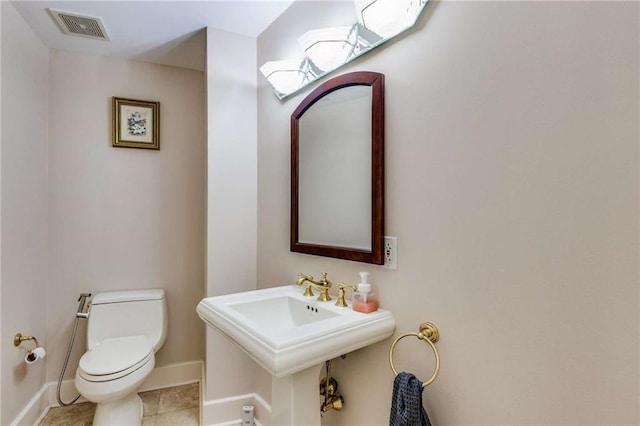 bathroom with tile patterned floors, toilet, and sink