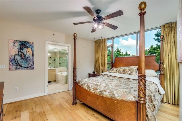 bedroom featuring floor to ceiling windows, ensuite bath, ceiling fan, and light hardwood / wood-style floors