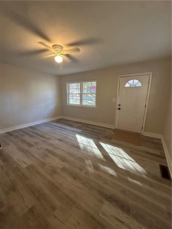 foyer featuring wood finished floors, visible vents, and baseboards