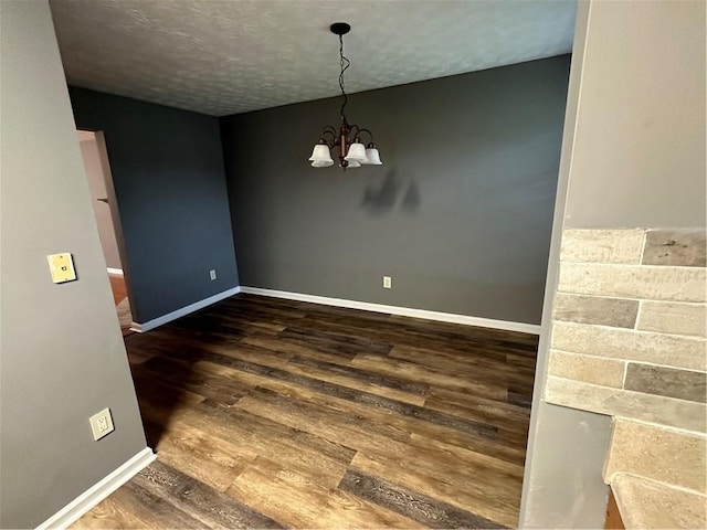 5768 Windgate Ln, Lithonia, GA 30058 - empty room with wood finished floors, a chandelier, and a textured ceiling