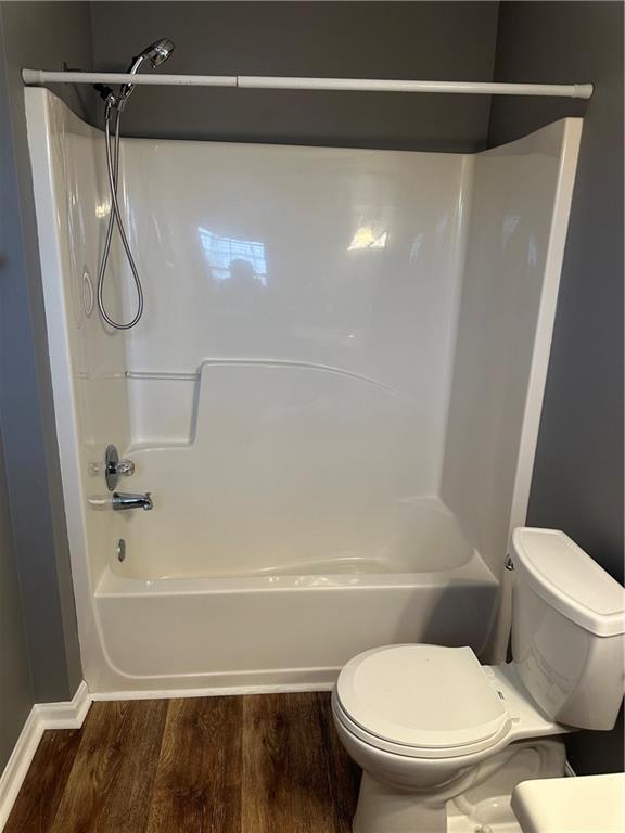5768 Windgate Ln, Lithonia, GA 30058 - bathroom featuring wood finished floors and  shower combination