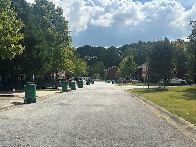 5768 Windgate Ln, Lithonia, GA 30058 - view of asphalt road with curbs and traffic signs