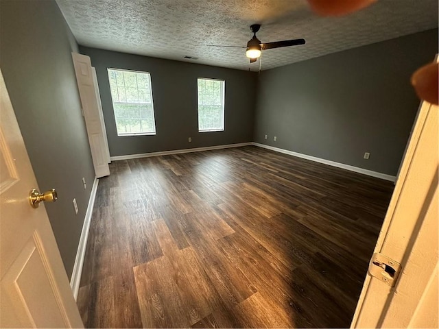 5768 Windgate Ln, Lithonia, GA 30058 - empty room with dark wood finished floors, a ceiling fan, and a textured ceiling
