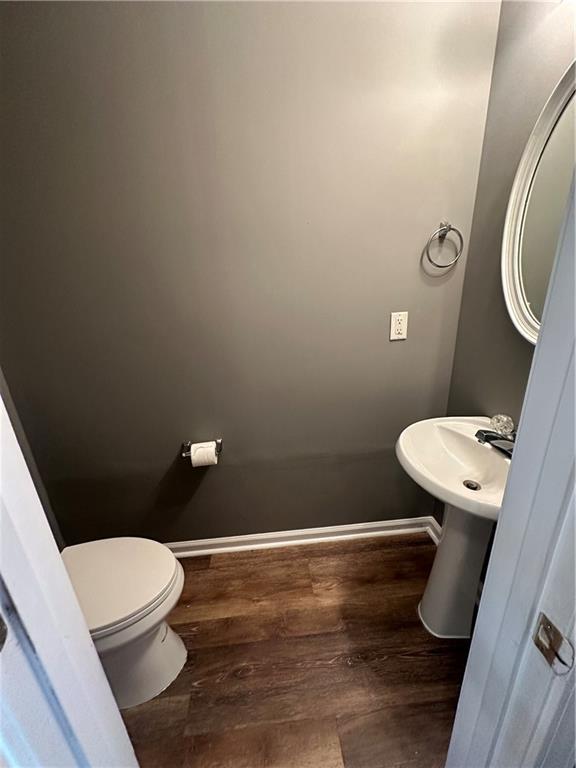 5768 Windgate Ln, Lithonia, GA 30058 - bathroom featuring wood finished floors and toilet