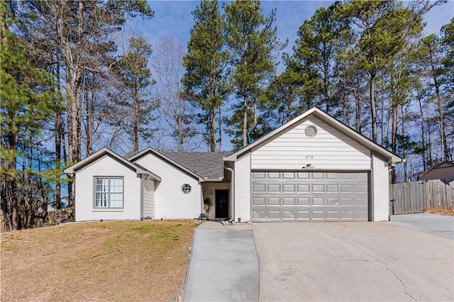 single story home with brick siding, an attached garage, a front yard, fence, and driveway