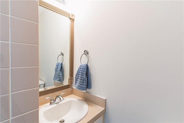 half bathroom featuring toilet and vanity