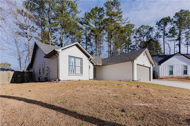 ranch-style home featuring a garage, concrete driveway, brick siding, and fence