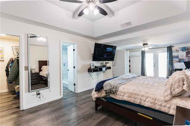 bedroom featuring baseboards, visible vents, wood finished floors, a walk in closet, and french doors