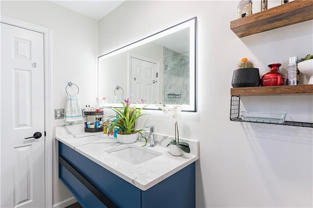 bathroom featuring walk in shower and vanity