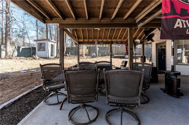 view of patio with fence and an outbuilding