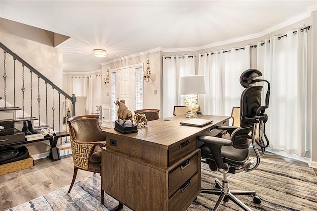 office space with crown molding and light wood-type flooring