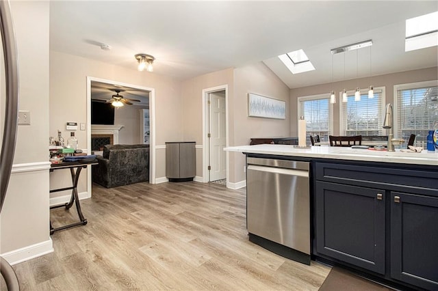 kitchen featuring pendant lighting, stainless steel dishwasher, a healthy amount of sunlight, and sink