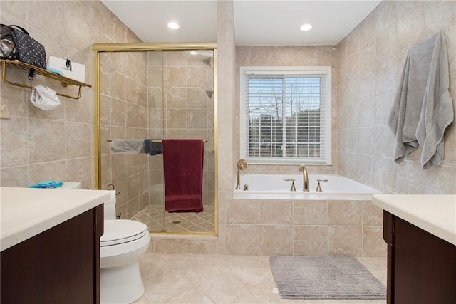 full bathroom featuring vanity, shower with separate bathtub, tile walls, and tile patterned floors