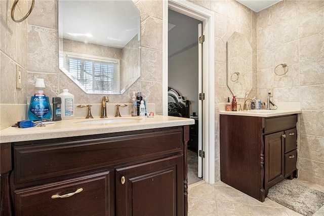 bathroom with tile patterned floors, vanity, tile walls, and backsplash