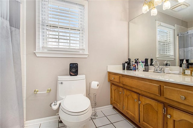 bathroom with vanity, plenty of natural light, tile patterned floors, and toilet