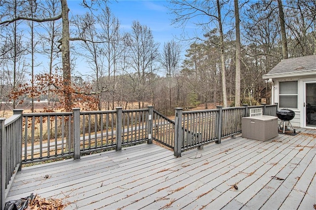 wooden terrace with a grill