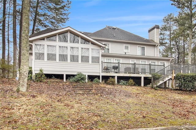 rear view of house featuring a wooden deck