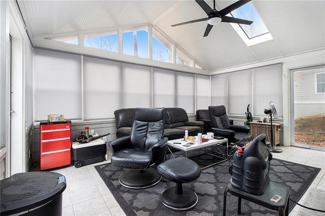 sunroom with ceiling fan, plenty of natural light, and vaulted ceiling with skylight