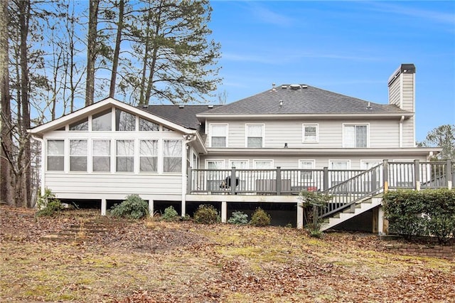 back of house featuring a wooden deck and a sunroom