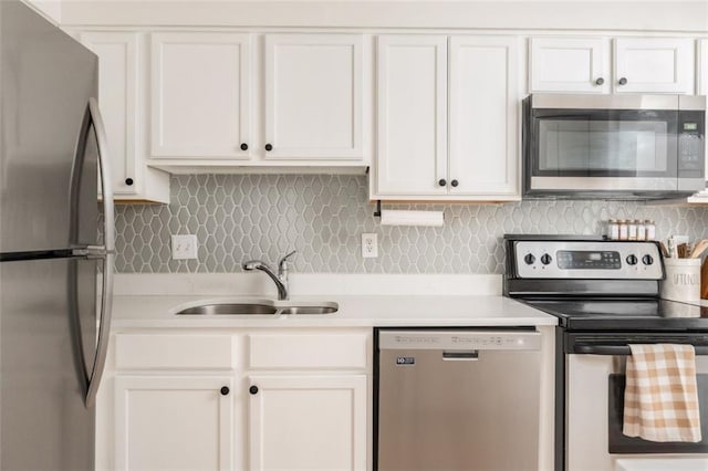 kitchen featuring white cabinetry, light countertops, appliances with stainless steel finishes, and a sink