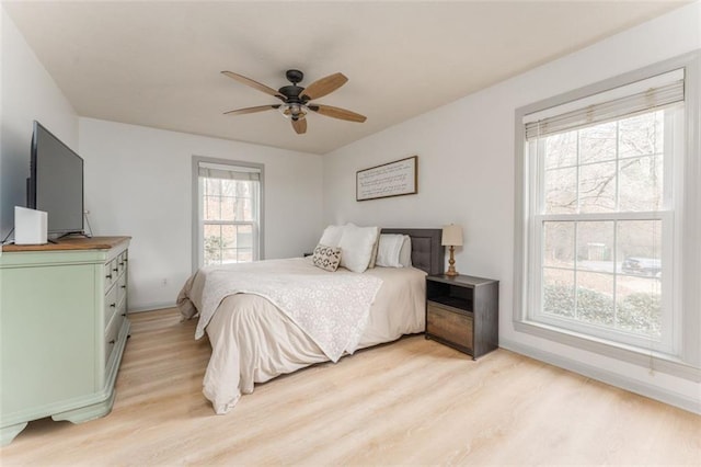 bedroom with light wood-type flooring and a ceiling fan