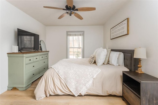 bedroom with ceiling fan and light wood-style floors