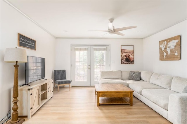 living room with light wood finished floors, french doors, ceiling fan, and ornamental molding