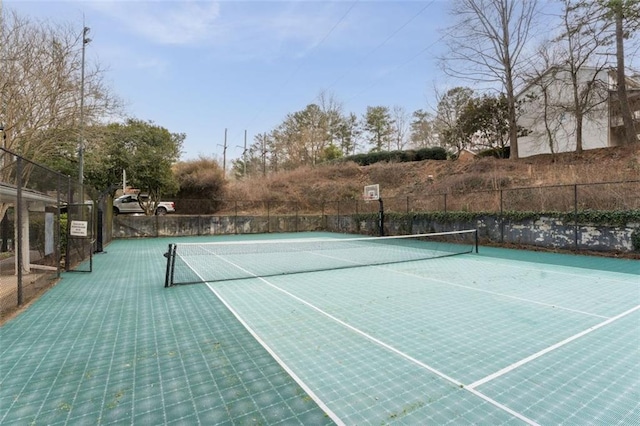 view of tennis court with fence