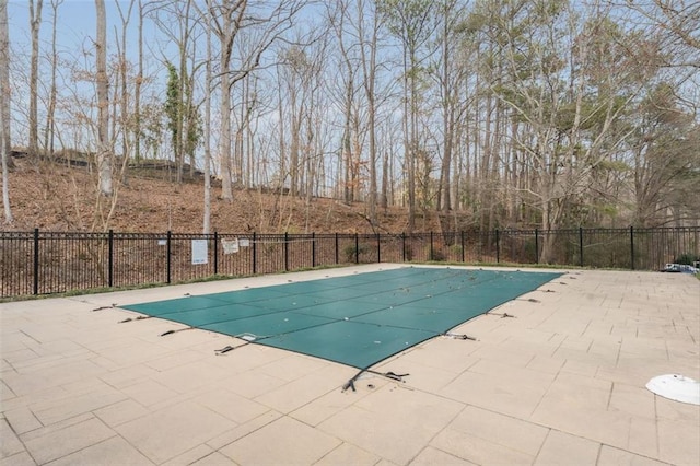 view of swimming pool featuring a fenced in pool, a patio area, and fence