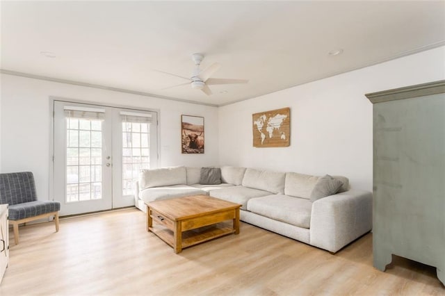 living area with light wood-type flooring, ceiling fan, ornamental molding, and french doors