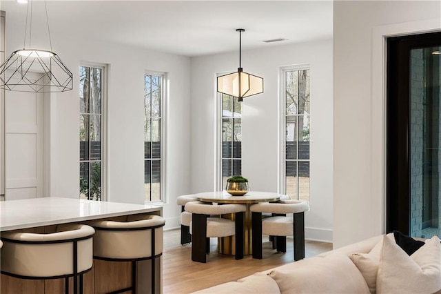 dining space featuring light wood-type flooring