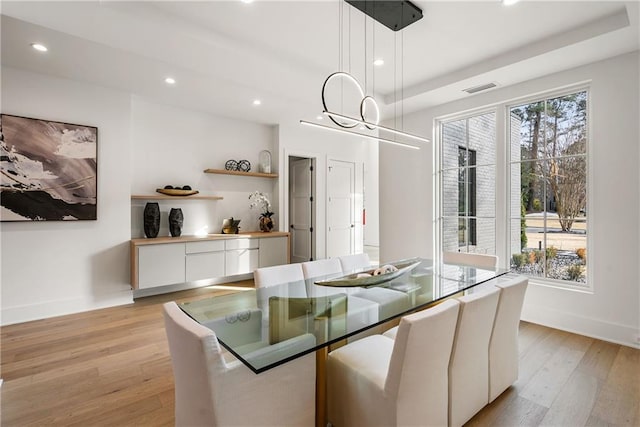 dining room featuring light hardwood / wood-style floors and a healthy amount of sunlight